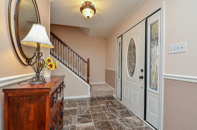 foyer entrance with marble finish floor, stairway, and baseboards