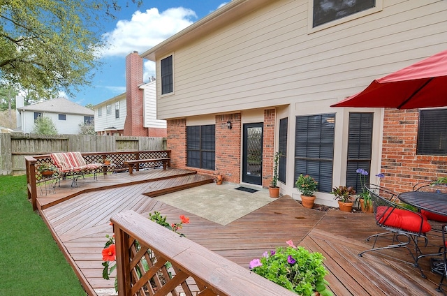 wooden terrace featuring fence