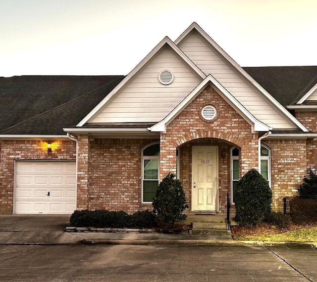 view of front of house with brick siding and an attached garage