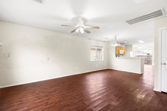 unfurnished living room featuring a ceiling fan, baseboards, visible vents, and dark wood-style flooring