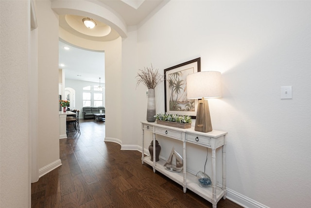 hall featuring dark wood finished floors and baseboards