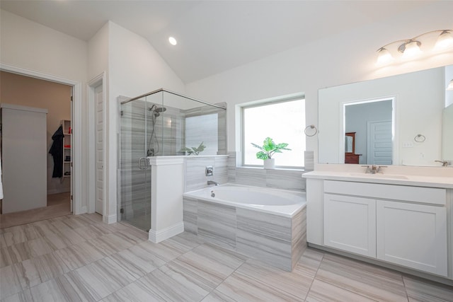 full bath featuring lofted ceiling, a stall shower, a bath, and vanity