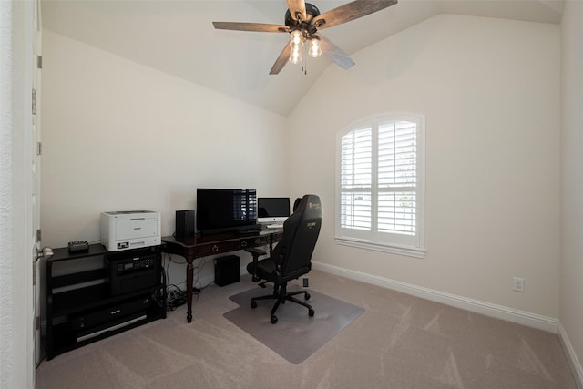 office area featuring light carpet, vaulted ceiling, a ceiling fan, and baseboards