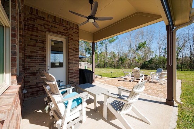 view of patio featuring ceiling fan and a fire pit