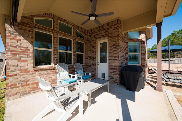 view of patio with fence, a ceiling fan, and a grill