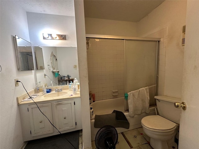 bathroom featuring enclosed tub / shower combo, toilet, tile patterned flooring, and vanity