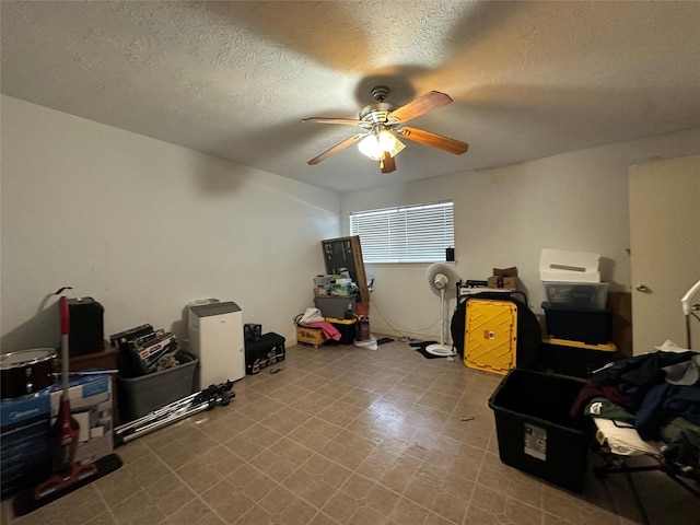 interior space with ceiling fan and a textured ceiling