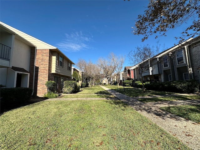 view of property's community featuring a yard and a residential view