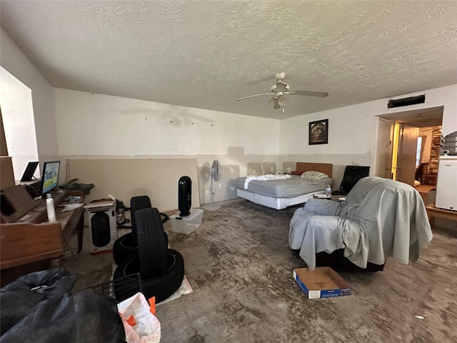 bedroom with a textured ceiling and ceiling fan