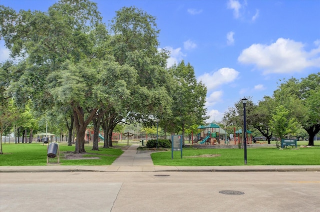 surrounding community featuring playground community and a lawn