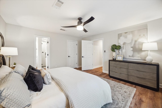 bedroom featuring baseboards, visible vents, and dark wood-type flooring