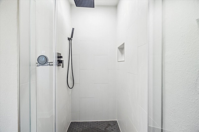 full bath with a tile shower