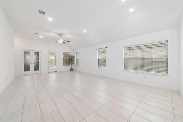 unfurnished living room featuring recessed lighting, visible vents, vaulted ceiling, and french doors