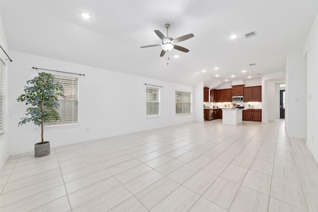 unfurnished living room with light tile patterned floors, recessed lighting, visible vents, a ceiling fan, and vaulted ceiling