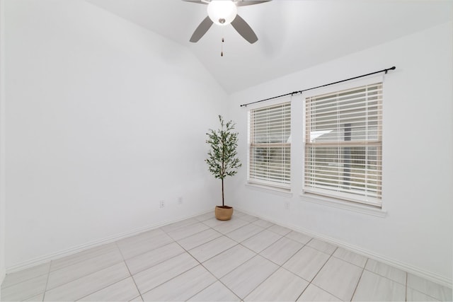 unfurnished room with a ceiling fan, lofted ceiling, baseboards, and light tile patterned floors