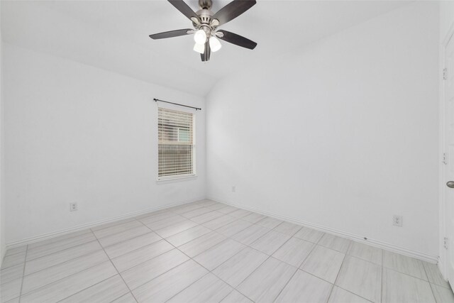 spare room with lofted ceiling, ceiling fan, and baseboards