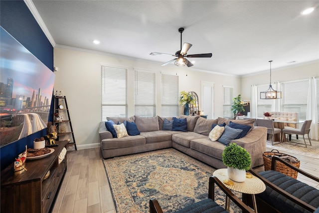 living room featuring baseboards, light wood-style flooring, ceiling fan, crown molding, and recessed lighting