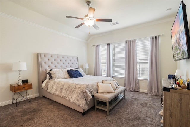 bedroom with baseboards, visible vents, vaulted ceiling, dark colored carpet, and crown molding