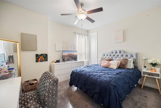 bedroom with dark carpet, baseboards, and ceiling fan