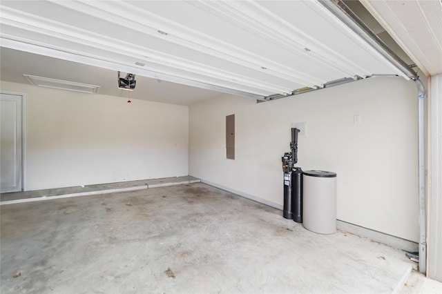 garage with a garage door opener and electric panel