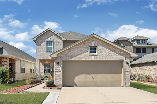 view of front of home featuring a garage, driveway, and brick siding