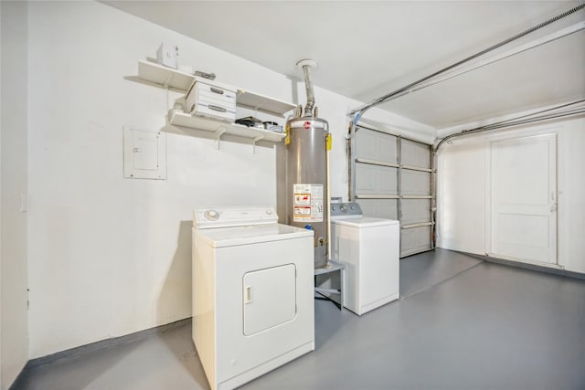 washroom featuring a garage, laundry area, water heater, and independent washer and dryer