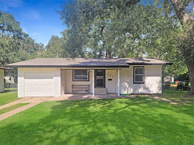 ranch-style home with entry steps, driveway, a garage, and a front lawn