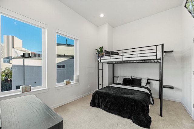 carpeted bedroom with baseboards, multiple windows, and recessed lighting