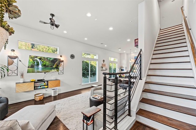 stairs with recessed lighting and wood finished floors