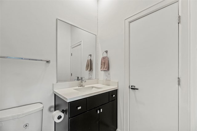 bathroom with toilet and vanity