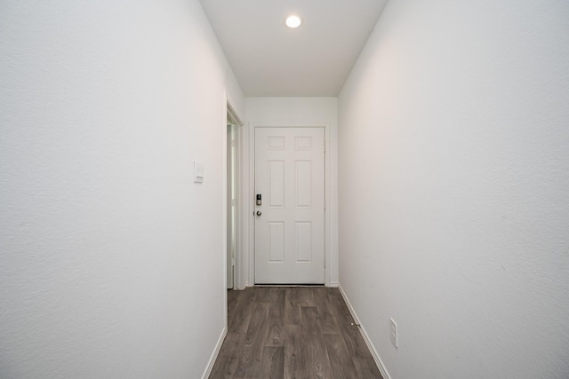 hallway featuring recessed lighting, dark wood finished floors, and baseboards