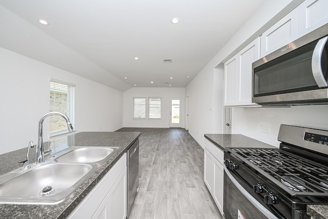 kitchen featuring stainless steel appliances, white cabinets, and a sink