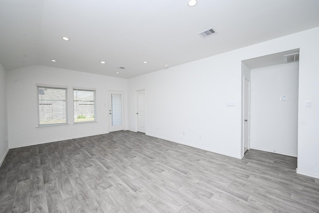 empty room with baseboards, wood finished floors, visible vents, and recessed lighting