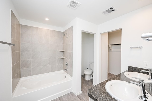 full bathroom featuring toilet, visible vents, and a sink