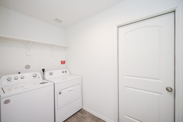 laundry room featuring laundry area, visible vents, and separate washer and dryer