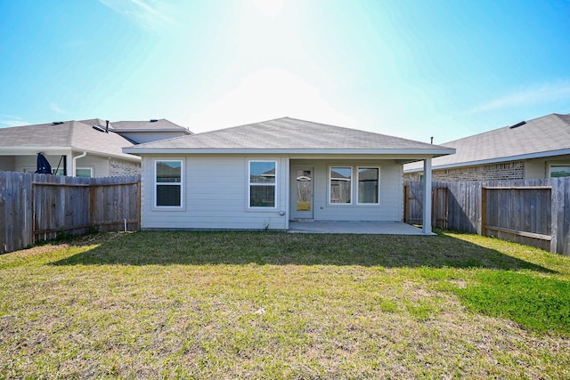 back of property featuring a patio, a lawn, and a fenced backyard