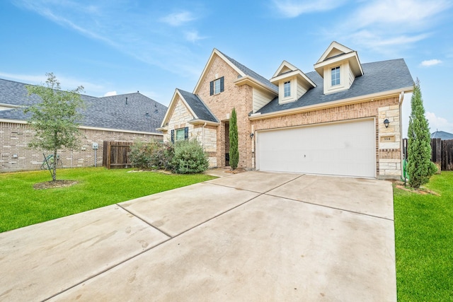 traditional home with brick siding, fence, concrete driveway, and a front yard