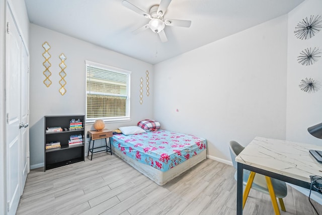 bedroom featuring ceiling fan, wood finished floors, and baseboards