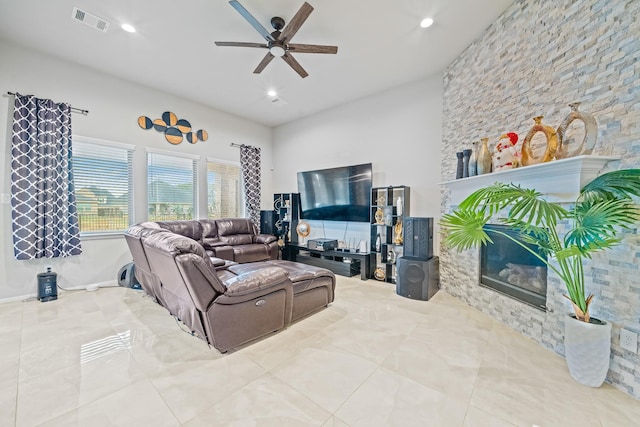 living room with a large fireplace, visible vents, a ceiling fan, tile patterned floors, and recessed lighting