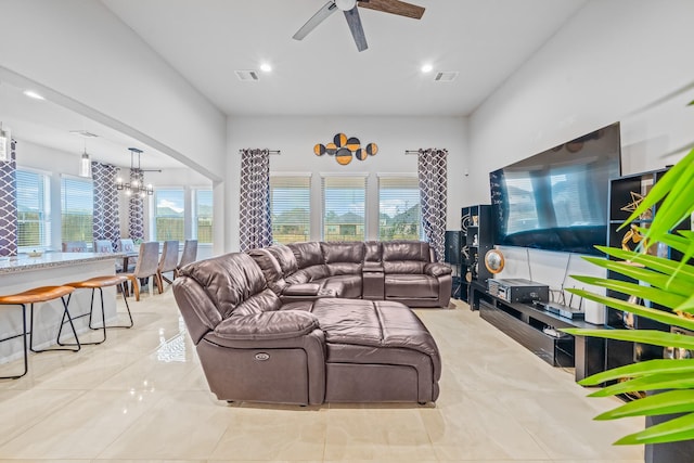 living room with recessed lighting, visible vents, tile patterned flooring, and ceiling fan with notable chandelier