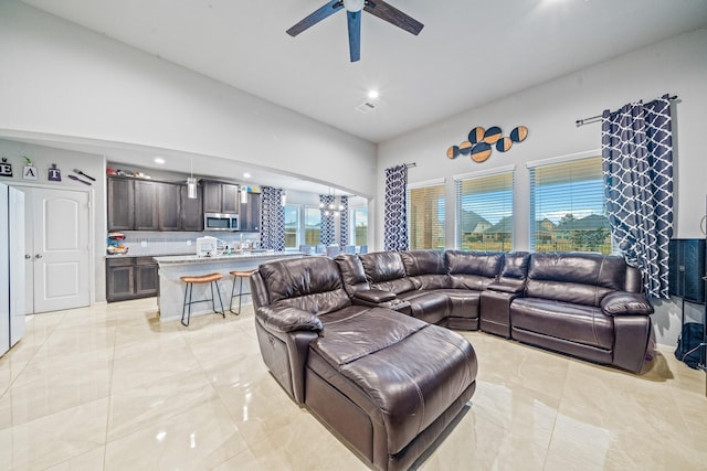 living room featuring a city view, recessed lighting, visible vents, high vaulted ceiling, and ceiling fan with notable chandelier