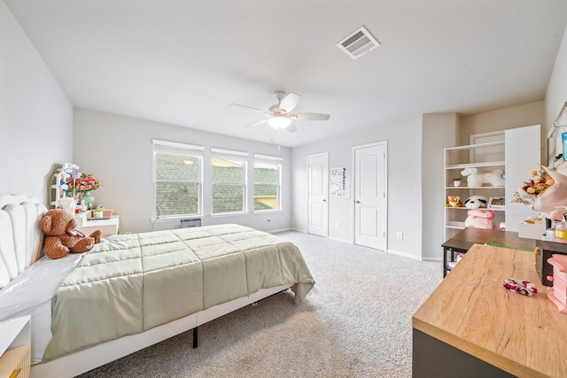 bedroom featuring ceiling fan, carpet flooring, visible vents, baseboards, and two closets