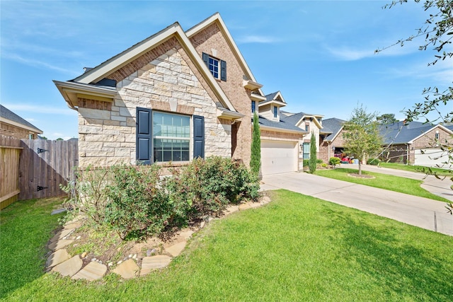 view of front of home with fence, a front yard, a garage, stone siding, and driveway