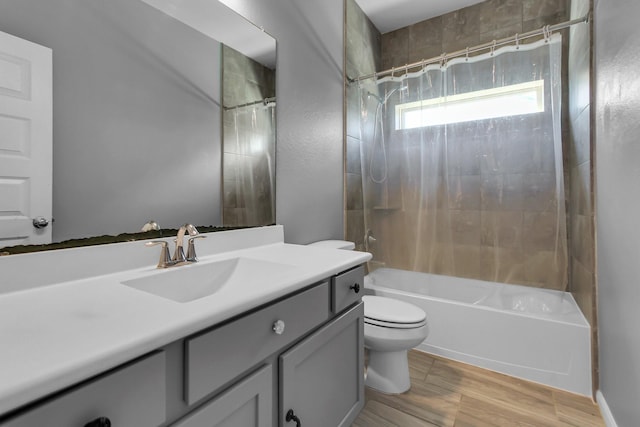 bathroom with vanity, wood finished floors, shower / tub combination, and toilet