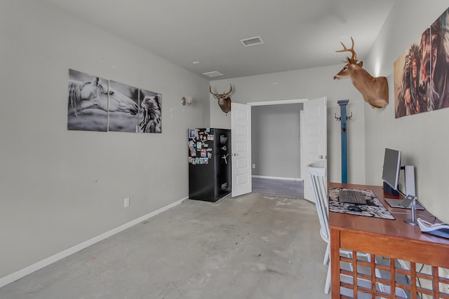 interior space with concrete floors, visible vents, and baseboards