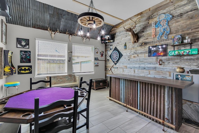 dining room with wood walls