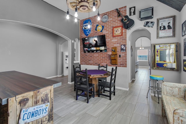 dining room with arched walkways and baseboards