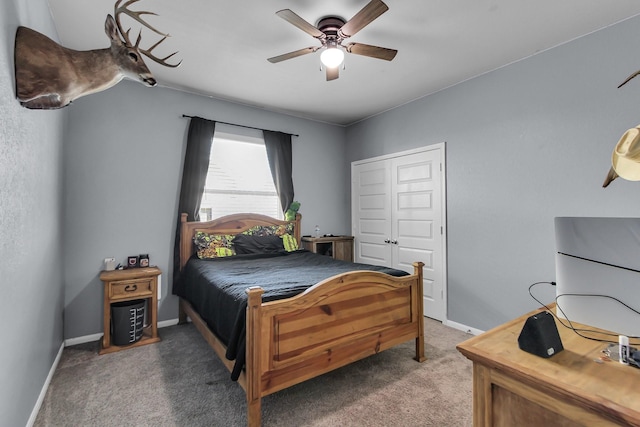 carpeted bedroom featuring a ceiling fan, a closet, and baseboards