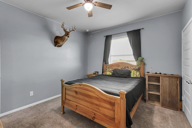 carpeted bedroom with ceiling fan and baseboards