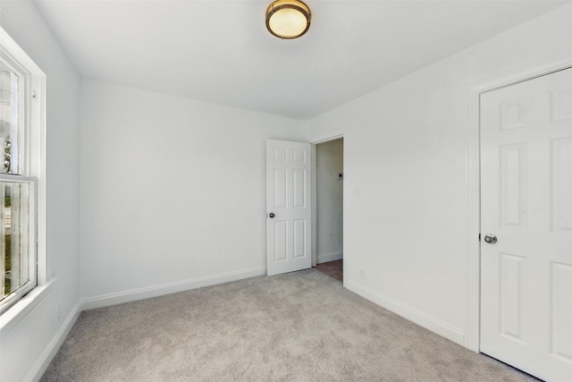 2430 5th Ave N, Texas City, TX 77590 - unfurnished bedroom with baseboards and light carpet